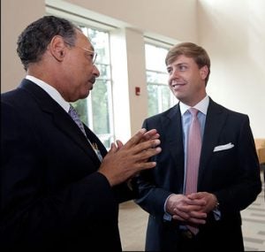 Dr. Paul Cunningham, dean of the Brody School of Medicine at ECU, speaks at Friday's ribbon-cutting ceremony with Robert Monk III, whose grandparents pledged $2.5 million to help build the geriatric center that bears their name.