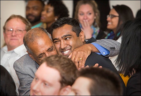 Parteek Singla gets a hug from his father after learning where he will be matched. (Photo by Jay Clark)