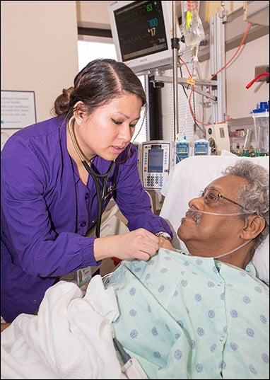 ECU nursing student Kimberley Le assists patient Roger Rice. The College of Nursing program at ECU requires nursing students to take at least one course in caring for older adults.