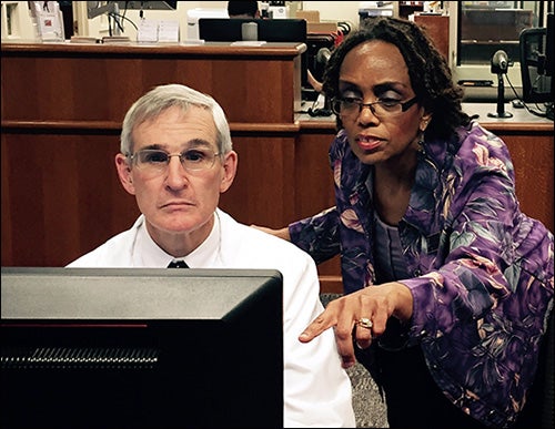 ECU nursing professor Dr. Pamela Reis, right, shows virtual patient details to Dr. Robert Carter, director of the General Practice Residency program for the ECU School of Dental Medicine.