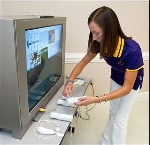 ECU graduate student Whitney Sauter (Recreation and Leisure Studies) prepares Nintendo Wii controllers for the seniors who use the equipment to play virtual games like bowling and golf.