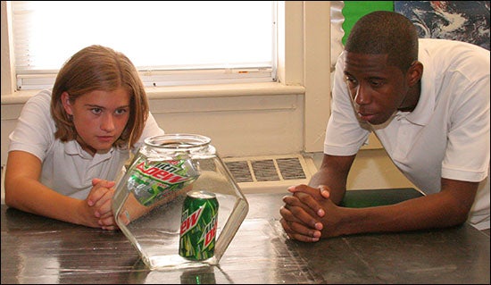 Middle schoolers observe as a sugar-free soda floats while the regular version sinks to the bottom. (Contributed photo)