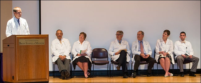 Seated during the annual White Coat Ceremony, from left, are Dr. Paul Cunningham, dean;  Dr. Elizabeth Baxley, senior associate dean for academic affairs; Dr. David Collier, president, BSOM Alumni Society; Dr. James Peden, Jr., associate dean for admissions; Dr. Susan Schmidt, associate dean for student affairs; and third-year medical student Kevin Harris, chair, Medical Student Council. 
