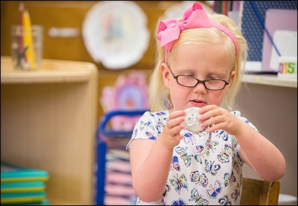 Preschooler Ainsley Taylor learns through play at the ECU center.