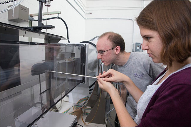 Working with the wind tunnel are engineering students Nicholas Garcia and Carrie Robinson.