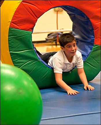 Pitt County student Gabriel Flores enjoys play during the ECU adapted physical education program.