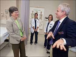 Greenville Mayor Pat Dunn, left, tours a physician assistant studies lab at ECU with students and Patrick Carter, interim chairman and clinical assistant professor of the department, at right. Photo by Cliff Hollis