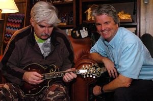 Dr. Bobby Jones, left, plays mandolin as his brother, Dr. Stephen Jones listens during a visit to Bobby Jones' Shelby home in August. Photo by Doug Boyd