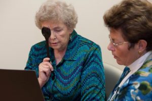 At right, Dr. Jane Painter, ECU professor and occupational therapist, checks Marjorie Everett's vision. Photo by Cliff Hollis, ECU News Services.