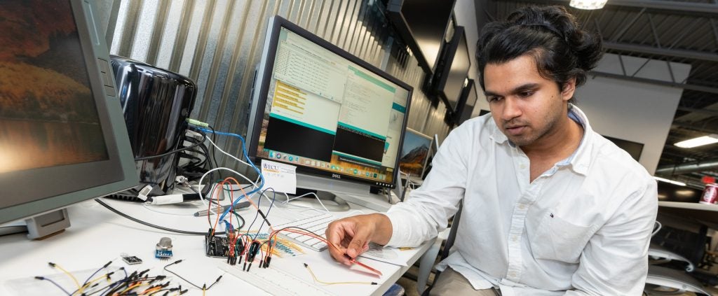 East Carolina University alumnus Magus Pereria tests a laser sensor that detects the depth of water at the university’s make-a-thon event. The event brought students and mentors together to develop ideas to combat challenges that arise from natural and man-made disasters.