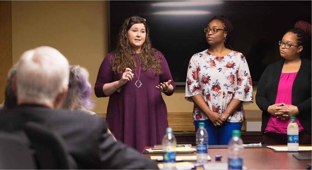 ECU students in the School of Social Work discuss their program with members of the HHP Advancement Council in the Rivers Building.