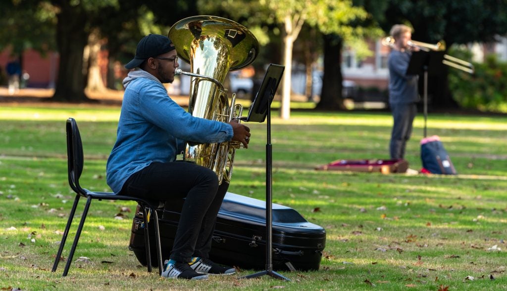 ECU senior Joshua Poyner plays the tuba during “Ponder.” About 32 brass musicians were spread out around the Cupola for the performance.