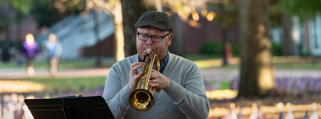 ECU music professor Dr. Travis Alford plays the trumpet during the outdoor performance of his composition “Ponder.”