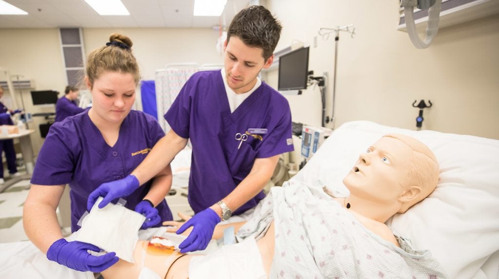 Nursing students participate in a wound simulation in one of the College of Nursing’s simulation labs. 