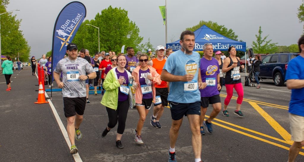 Runners take off from the start line at the ECU Alumni Road Race on Saturday.