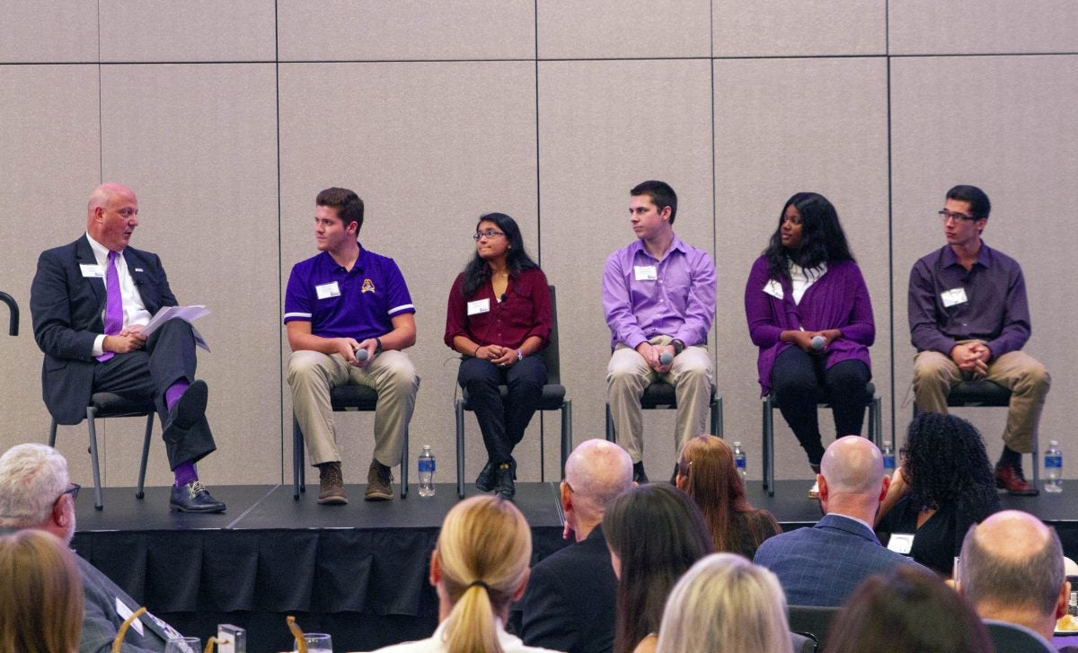 Vice Chancellor for University Advancement Christopher Dyba, left, speaks to a panel of students about their Access Scholarships.