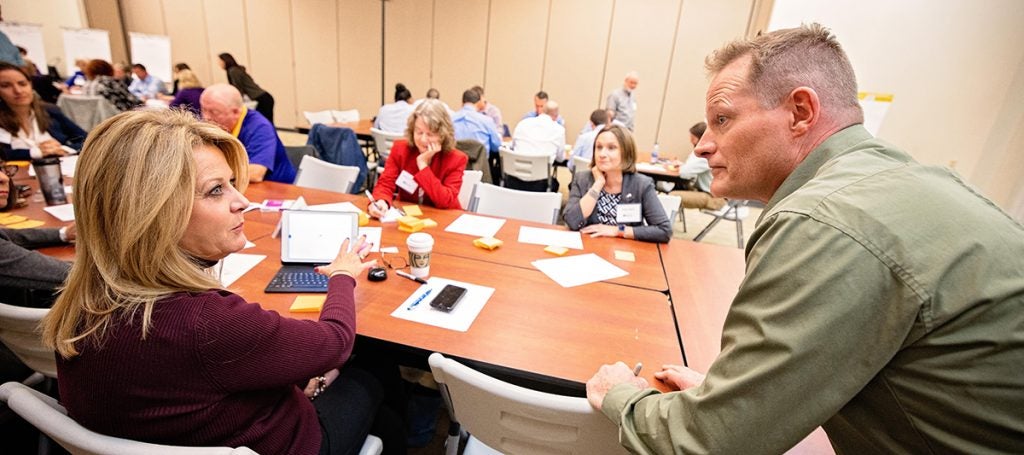 Connie Osment of Valley Proteins talks with Gerald Weckesser of ECU during the Economic Growth Collaboratory on Nov. 4.