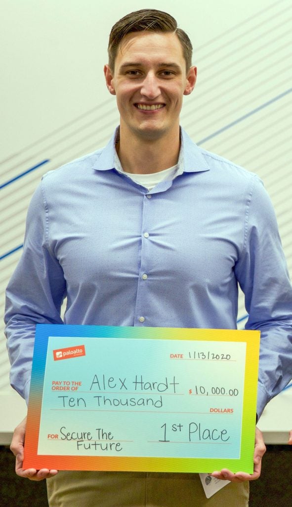 Hardt stands with his first-place prize of $10,000 for winning the Palo Alto Networks Secure the Future cybersecurity competition.