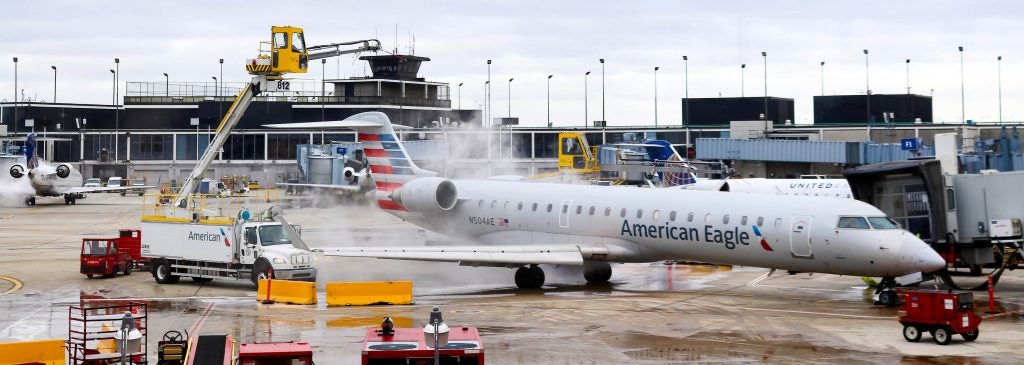 An American Eagle aircraft is deiced at O’Hare Airport in Chicago. Dr. Yang Liu, an engineering professor at East Carolina University, is conducting research to help improve anti-icing and deicing techniques to help improve airline safety.