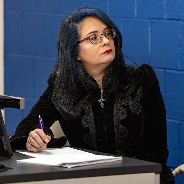 Assistant professor Angela Raper, dressed in period clothing, listens to Fresquez give a presentation during her role-playing class in Bate Building.
