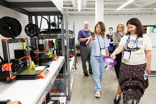 Zaya Sanjaa, right, and Zhannura Saidmuratova tour the Wornom Makerspace in the Isley Innovation Hub.