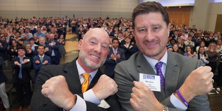 Matt Crisp and Mike Harris with an auditorium full of COB students, faculty and friends of the college.