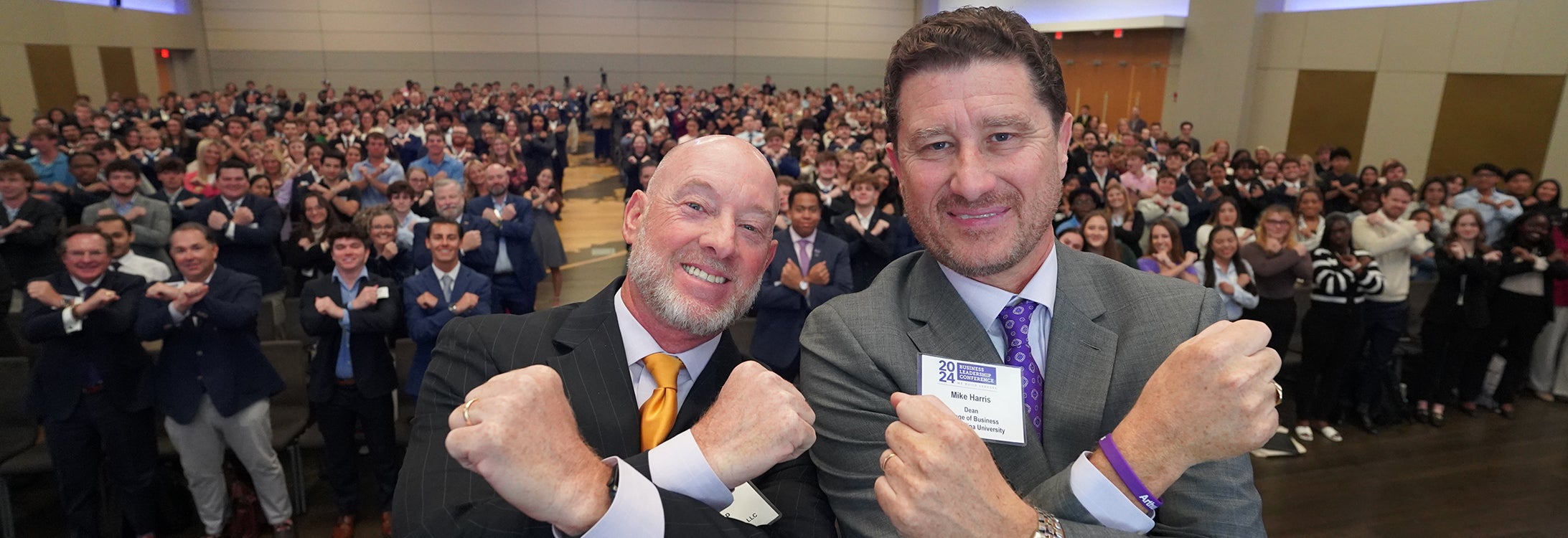 Matt Crisp and Mike Harris with an auditorium full of COB students, faculty and friends of the college.