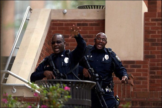 Police officers direct people to move out of the area around the West End Dining Hall after reports of an armed suspect in the vicinity of Fifth St. and Reade Circle. (Photos by Cliff Hollis)