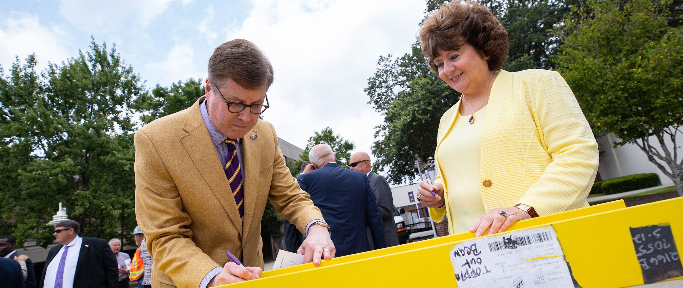 Chancellor Cecil Staton, left, and Catherine Staton sign the final steel beam for the Southside Expansion