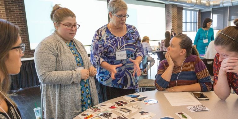 Project CONVEY principal investigator Dr. Sandra Warren, center, speaks with graduate students, from left, Ashton Boyarsky, Allison Skinner, Samantha Ruppe Beard and Meredith Clark, who are part of the project’s first cohort during the CONVEY summer institute on Tuesday, June 19.