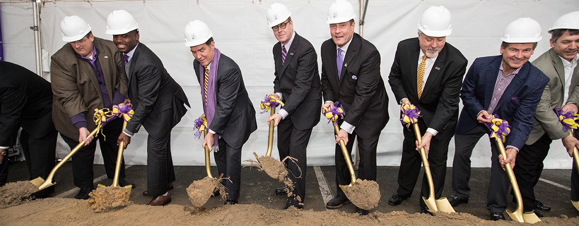 ECU football coach Scottie Montgomery, ECU board chairman Kieran Shanahan, ECU Chancellor Cecil Staton, Athletic Director Jeff Compher, Vice Chancellor of Administration and Finance Rick Niswander and others ceremonially shovel dirt during a celebration of a $60 million renovation and construction project at Dowdy-Ficklen Stadium.