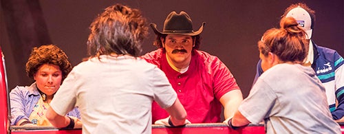Matt Donahue as Benny Perkins eyes the competition in “Hands on a Hardbody.” To his right, Jessica Blair Rogers portrays Norma Valverde.