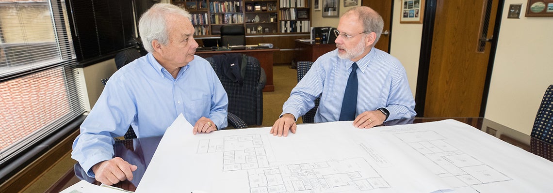 Dr. Stan Eakins, College of Business dean and Dr. Harry Ploehn, College of Engineering and Technology dean, review the current layout of the building that will become the Isley Innovation Building.
