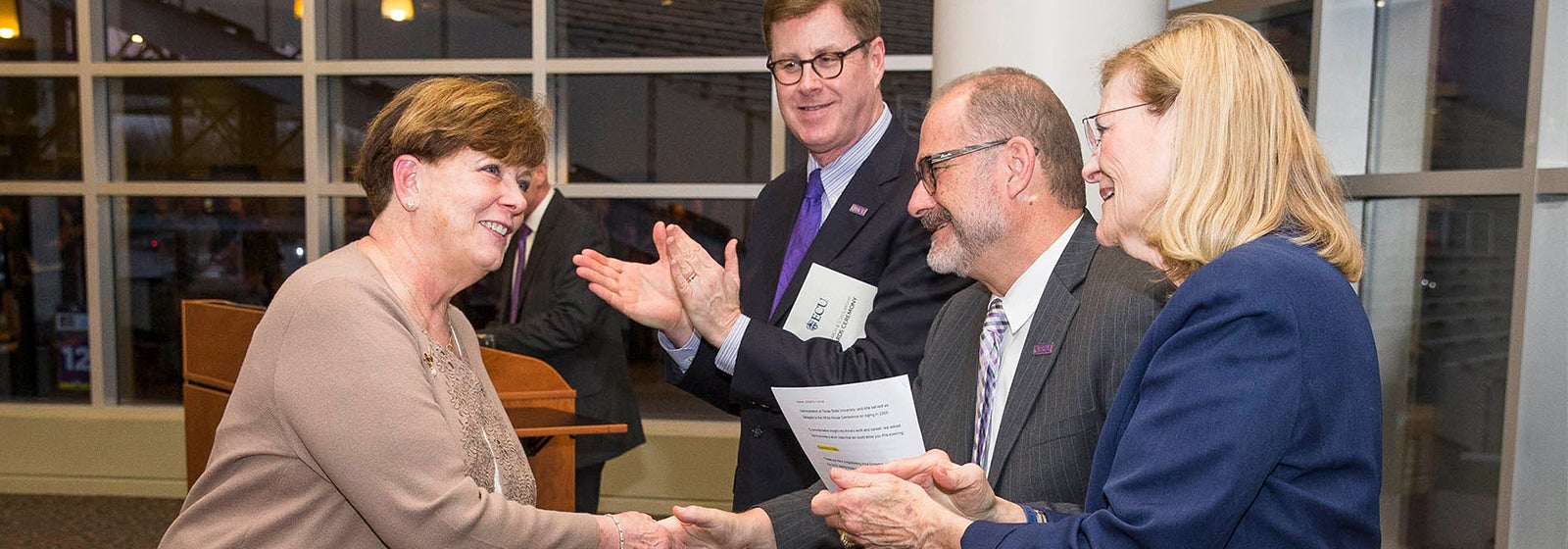Anne Dickerson (left) is congratulated by ECU Chancellor Cecil Staton (from center), Provost Ron Mitchelson and Vice Chancellor Phyllis Horns after receiving the Lifetime Research and Creative Activity Award. (Photos by Cliff Hollis)