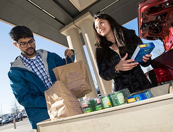 Third-year medical students Shazeb Khan and Shannon Osborne collect items for a new food pantry at ECU’s Brody School of Medicine.