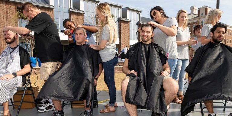 ECU Pirates cut their hair to raise money for pediatric cancer research during the 2018 Pirates Vs. Cancer event. (Photos by Cliff Hollis)