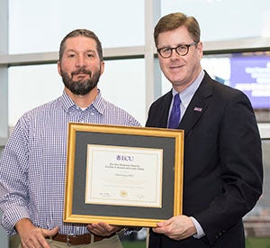 Chris Geyer is presented the Five-Year Research and Creative Activity Award by ECU Chancellor Cecil Staton.