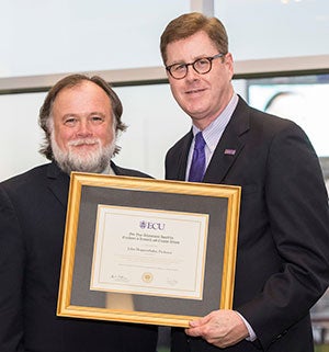 John Hoppenthaler is presented the Five-Year Research and Creative Activity Award by ECU Chancellor Cecil Staton.