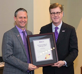 Chris Stansbury accepts the James R. Talton Jr. Leadership Award from Chancellor Cecil Staton.