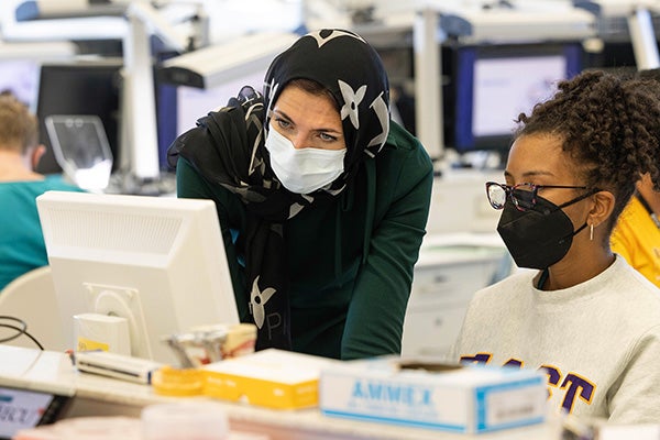 ECU School of Dental Medicine faculty member Dr. Hanan Elgendy works with students in the school’s Preclinical Technique Lab in Ross Hall.