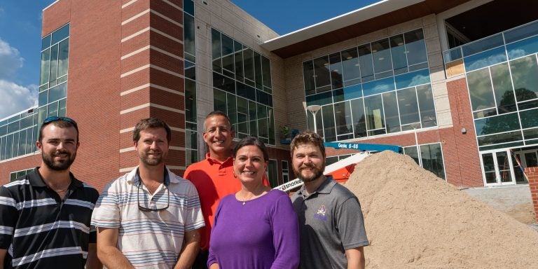 Justin Spears (left), Scott Andrews, Tom Daniel, Jenny Sutton and Chris Denton in front of the new Main Campus Student Center.