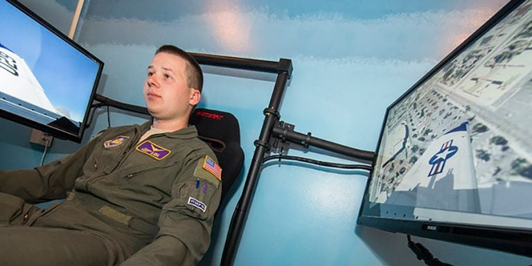 A student sits in the ECU Air Force ROTC flight simulator in Wright Annex.