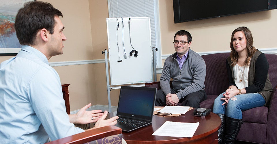 ECU doctoral student Dan Blocker and graduate student Meagan Collins are working with Drs. Jake Jensen, foreground, and Matt Fish, not pictured, on a study to determine how confiding in friends about relationship problems is linked to the overall quality of the relationship. (Photos by Cliff Hollis)