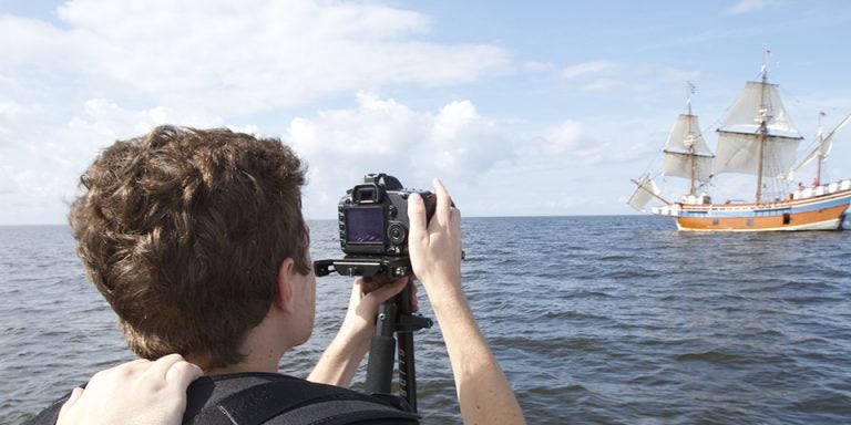 ECU graduate Ryan Shackleford films the Elizabeth II, a replica of a 1500’s sailing vessel, near Manteo in fall 2014 as part of his class film, “A Colony Lost.”