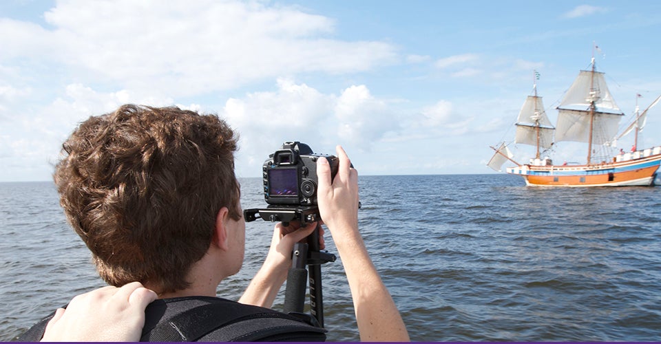 ECU graduate Ryan Shackleford films the Elizabeth II, a replica of a 1500’s sailing vessel, near Manteo in fall 2014 as part of his class film, “A Colony Lost.”