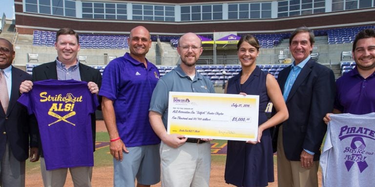 Attending the ALS check presentation were, left to right, Willie Lee, auxiliary services director at ECU; Bryan Tuten, director of the Dowdy Student Stores; Head ECU Baseball Coach Cliff Godwin; John Palmer, merchandise and apparel manager for Dowdy Student Stores; Stephanie West with the ALS Association Jim 