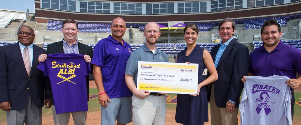 Attending the ALS check presentation were, left to right, Willie Lee, auxiliary services director at ECU; Bryan Tuten, director of the Dowdy Student Stores; Head ECU Baseball Coach Cliff Godwin; John Palmer, merchandise and apparel manager for Dowdy Student Stores; Stephanie West with the ALS Association Jim 