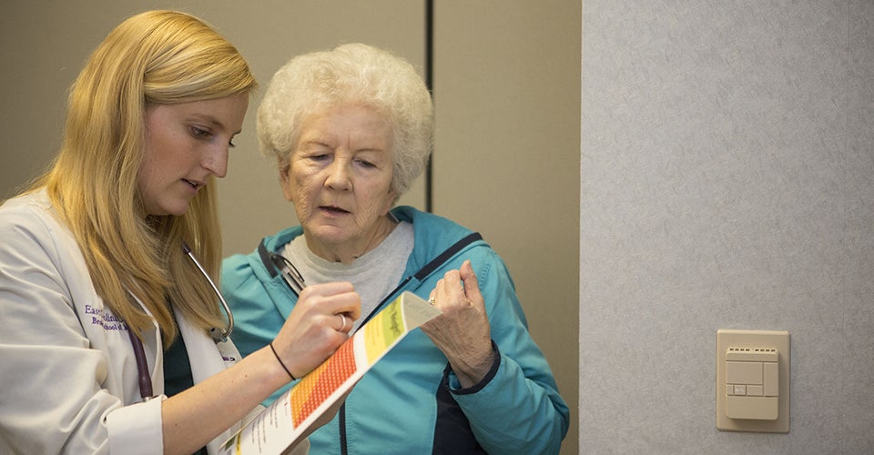 A Brody student treats a patient at the Tarboro Stroke Clinic in 2013. (Photos by Cliff Hollis)