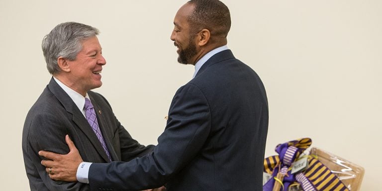 Board of Trustees member Danny Scott presents a gift to Chancellor Steve Ballard. (Photos by Cliff Hollis)