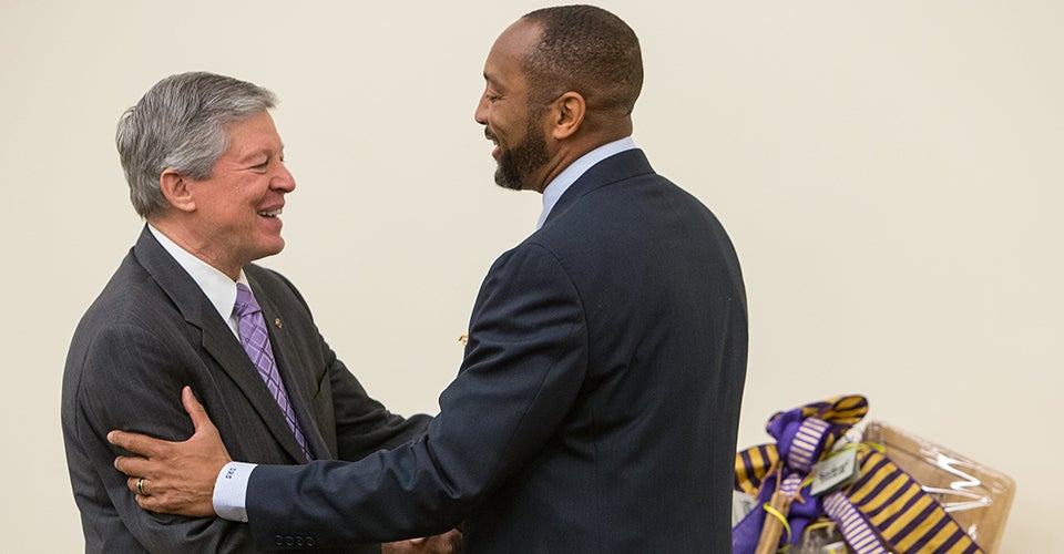 Board of Trustees member Danny Scott presents a gift to Chancellor Steve Ballard. (Photos by Cliff Hollis)